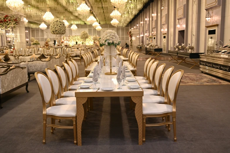 there are several tables and chairs with centerpieces set up