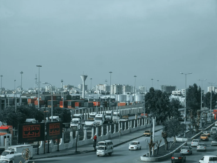 traffic moving along a busy highway with tall buildings in the background