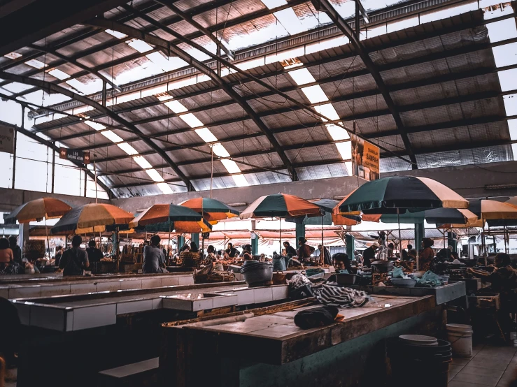 a long outdoor market is full of customers