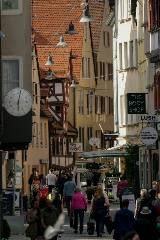 people walk down a crowded street in the city