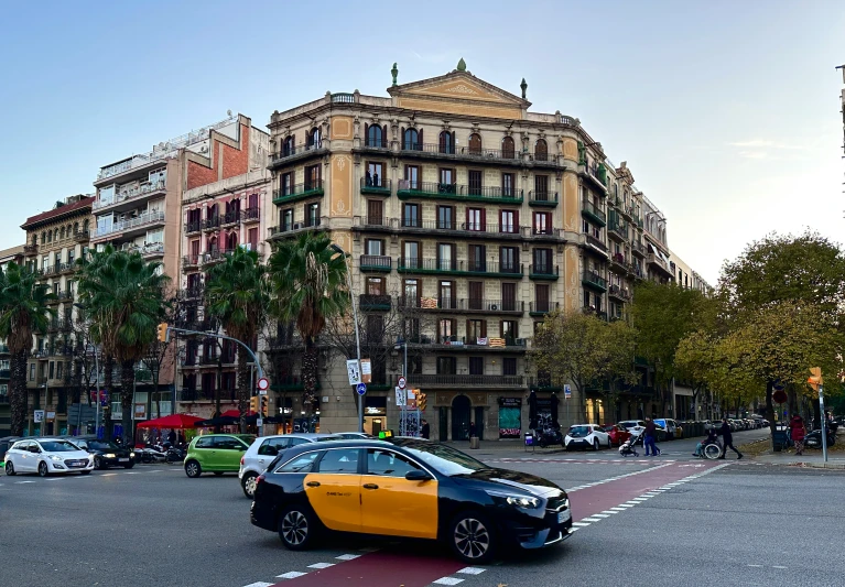 there is a black and yellow car stopped at the corner