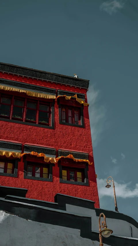 a red building with a black sky behind it