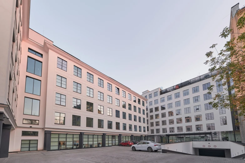 a parking lot in front of a building with parked cars