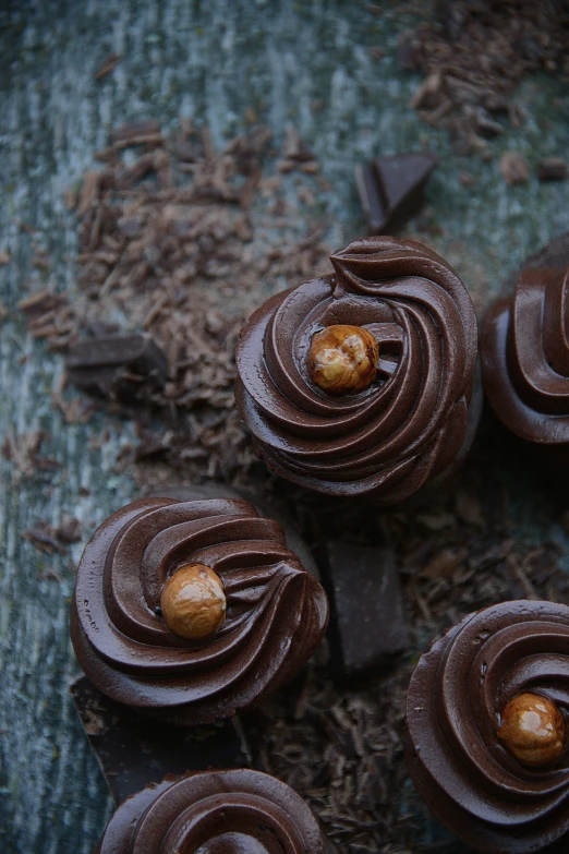 four cookies covered in chocolate and golden eggs on top of each other