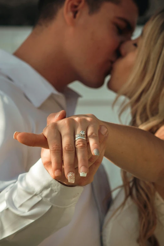 two people holding hands to kiss each other