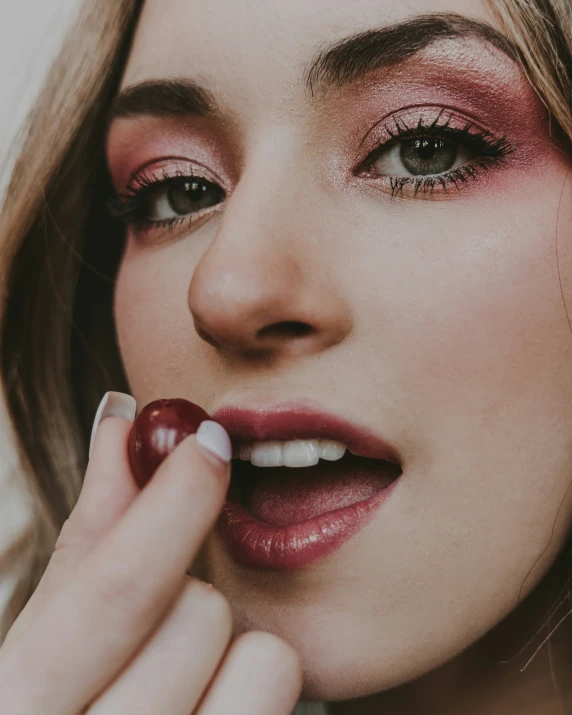 a close up view of a woman holding a candy bar