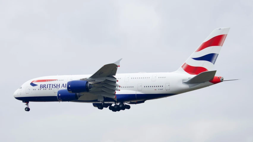 a large passenger jet flying through a gray sky