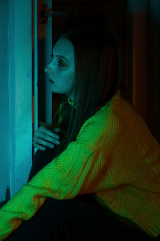 a young woman holding onto a green light up