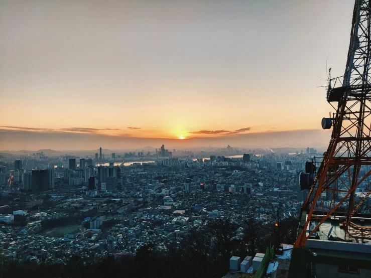 a view from the top of a tower with a sunset behind it