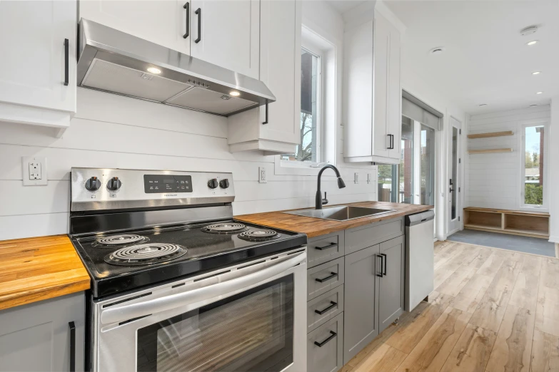 a kitchen with a stove, microwave and cupboards