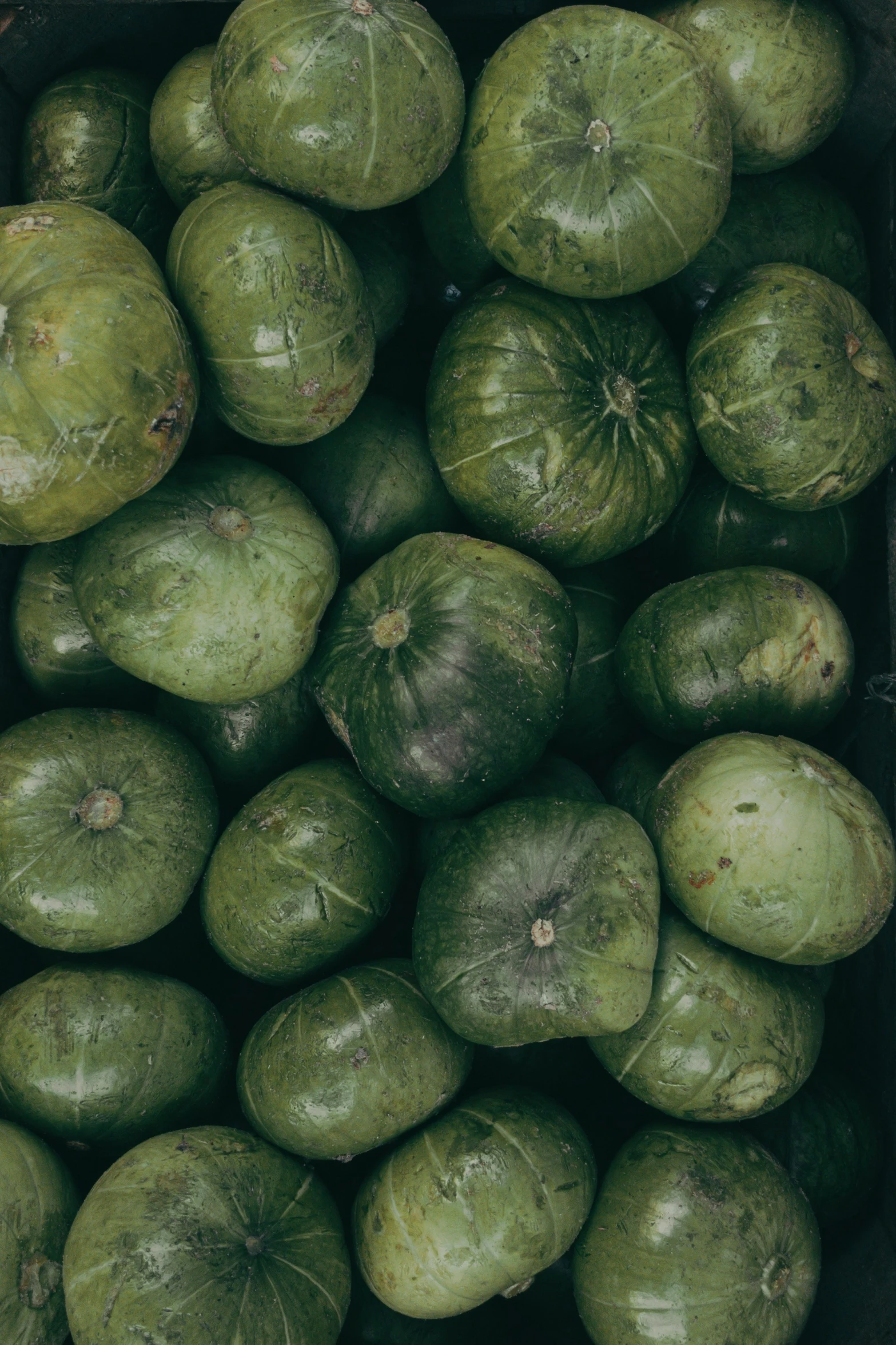 green fruit is in a box on a table