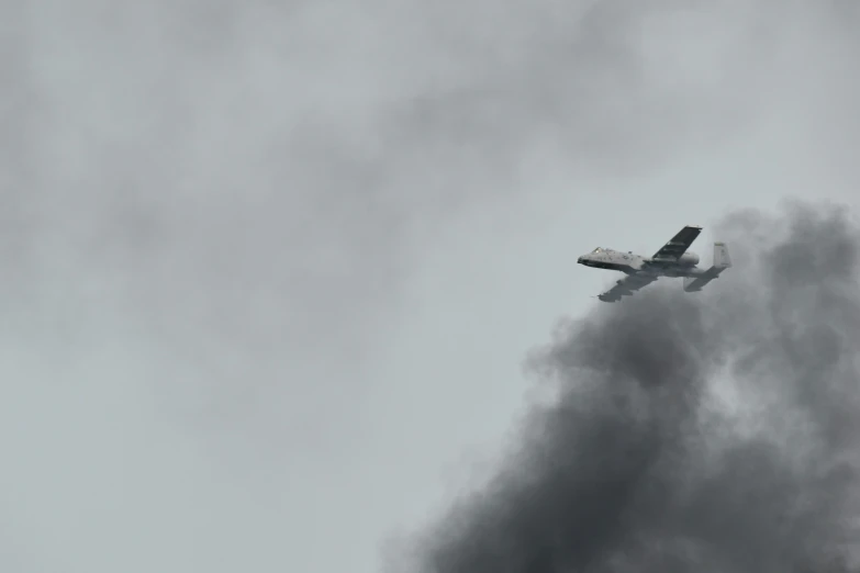 a small airplane is flying through dark clouds