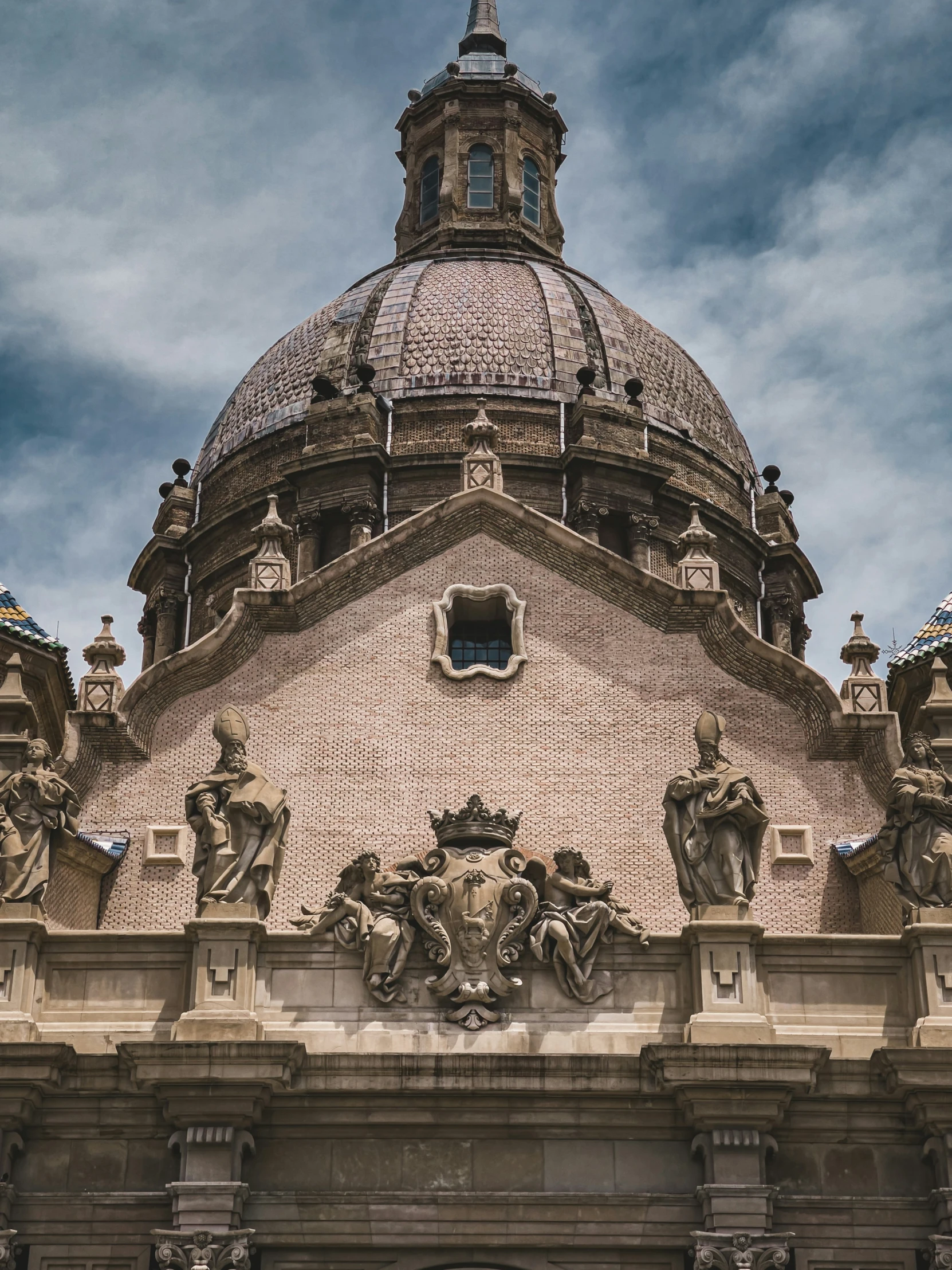 a dome sitting over a tall brown building