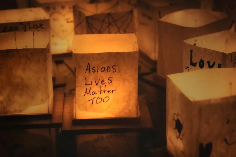 lit candles that are written on to some boxes