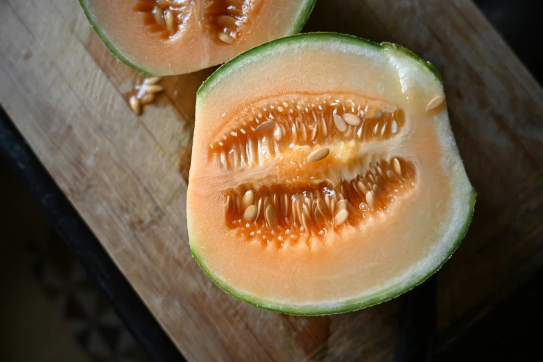 sliced watermelon and a knife on a wooden  board