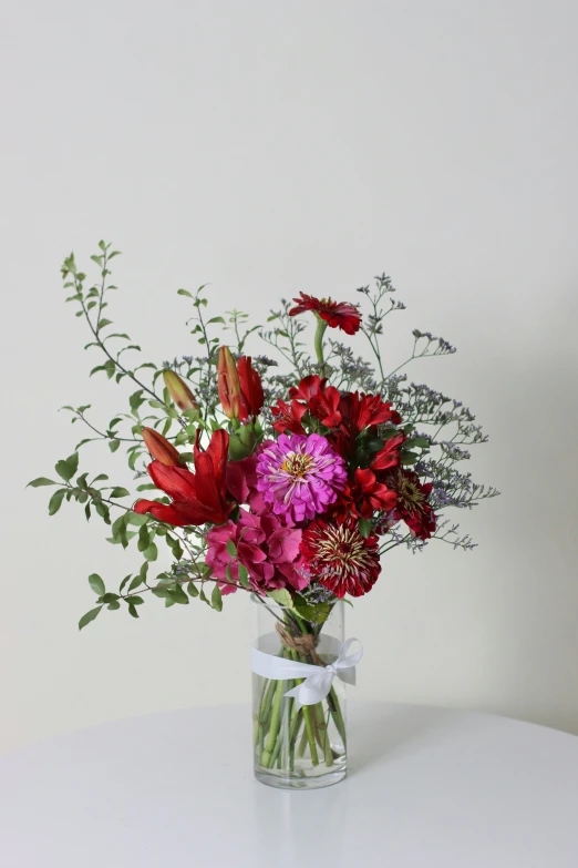 a vase filled with different kinds of flowers