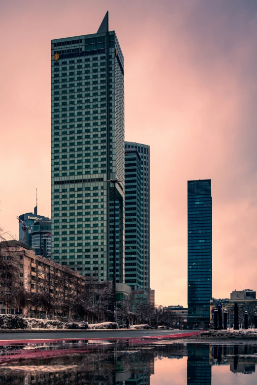 a very tall building towering over a body of water