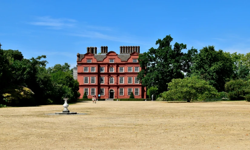 a big house with some bushes around it