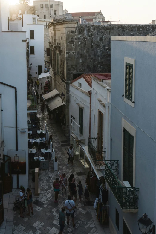 a group of people standing in an alley way