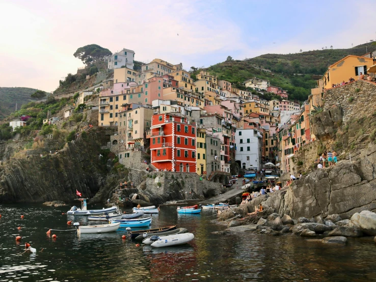 a group of boats are on the water near many buildings