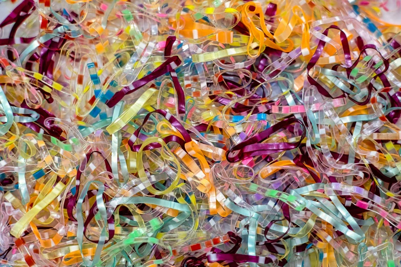 a pile of different colored shredded plastic letters