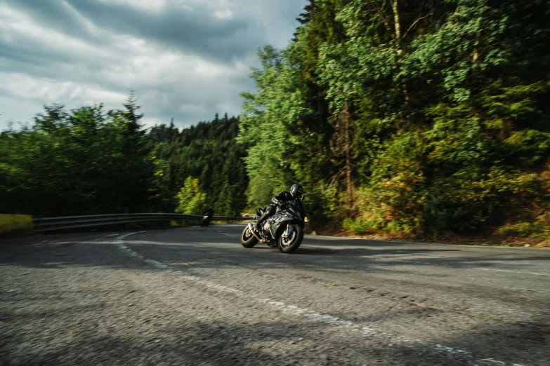 a person riding a motorcycle down the road