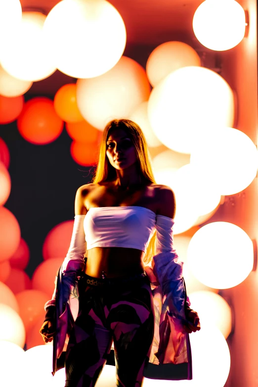 a woman is posing in front of some bright circles