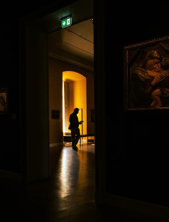 an older man is silhouetted against a bright doorway