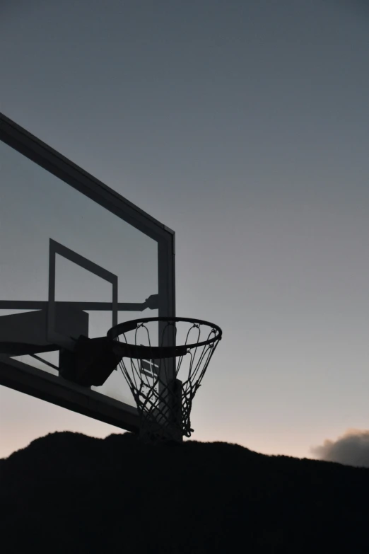 a basketball is going through the rim in an alley