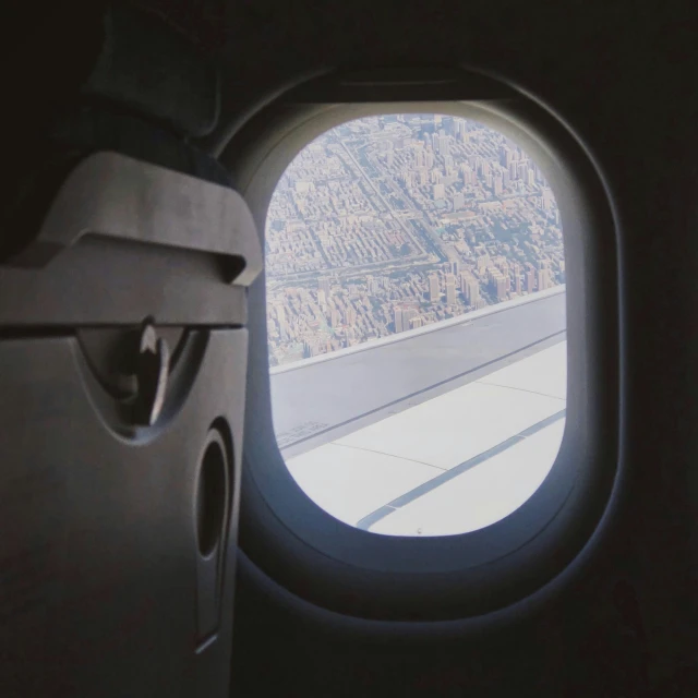 view out an airplane window shows the wing of the plane