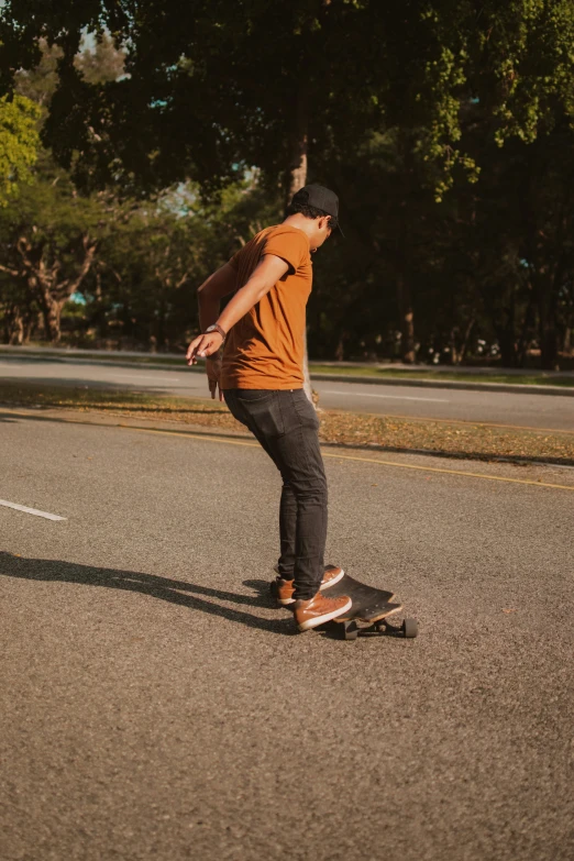 a man riding his skateboard on the road