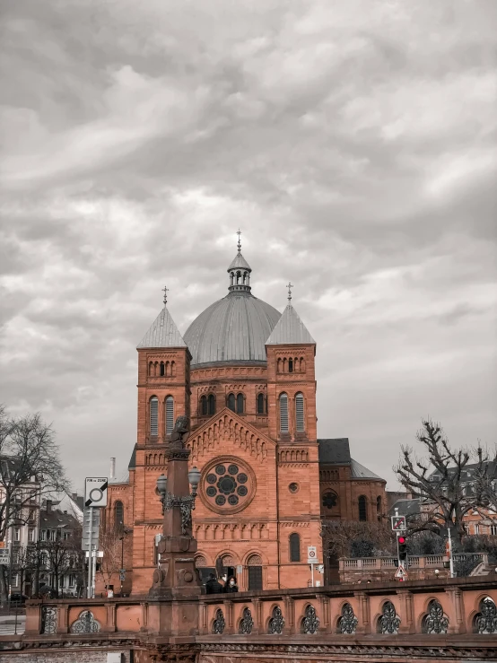 the large building is orange with two tower tops