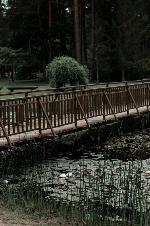 an old bridge and benches across a river