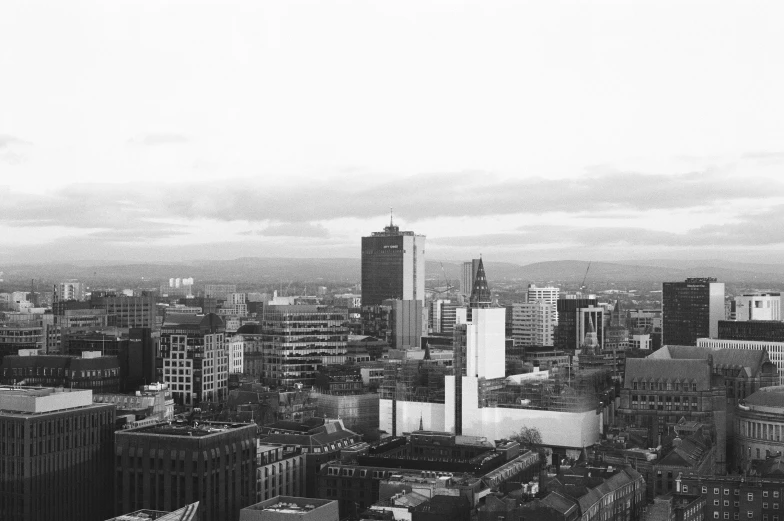 an aerial view of some tall buildings on a cloudy day