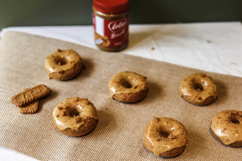 nine iced donuts are on a table