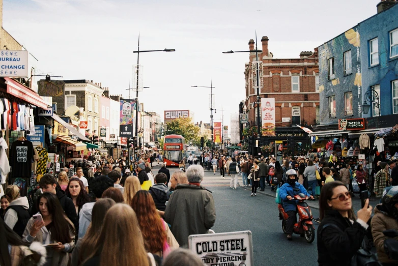 large group of people walking down a crowded street