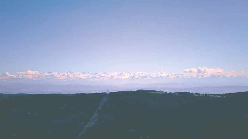 a distant view of the mountains, in a blue sky