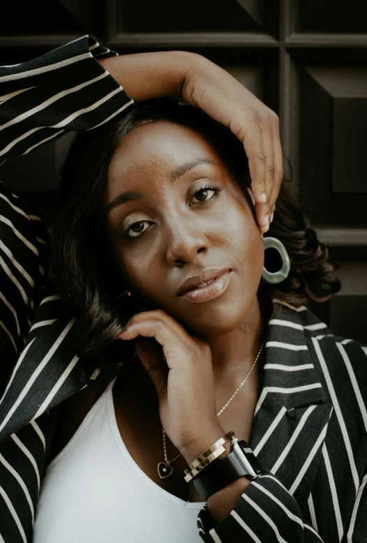 a woman in striped jacket standing by the door