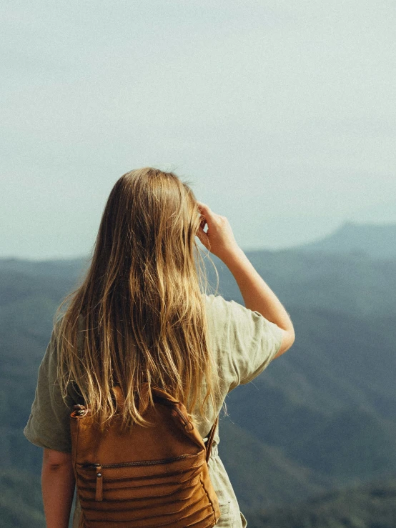 the back of a woman with her hair blowing in the wind