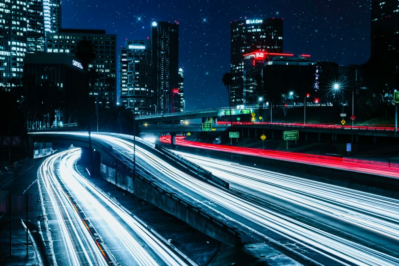 a cityscape with traffic going by at night