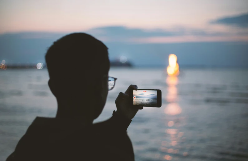 a man takes a po of the ocean