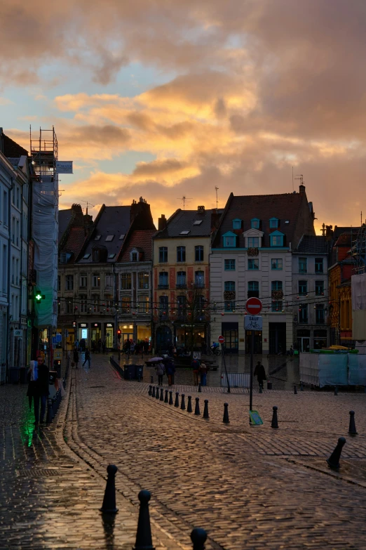 a street lined with buildings at sunset or dawn