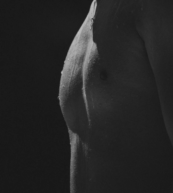 the back end of a women's chest in a dark room