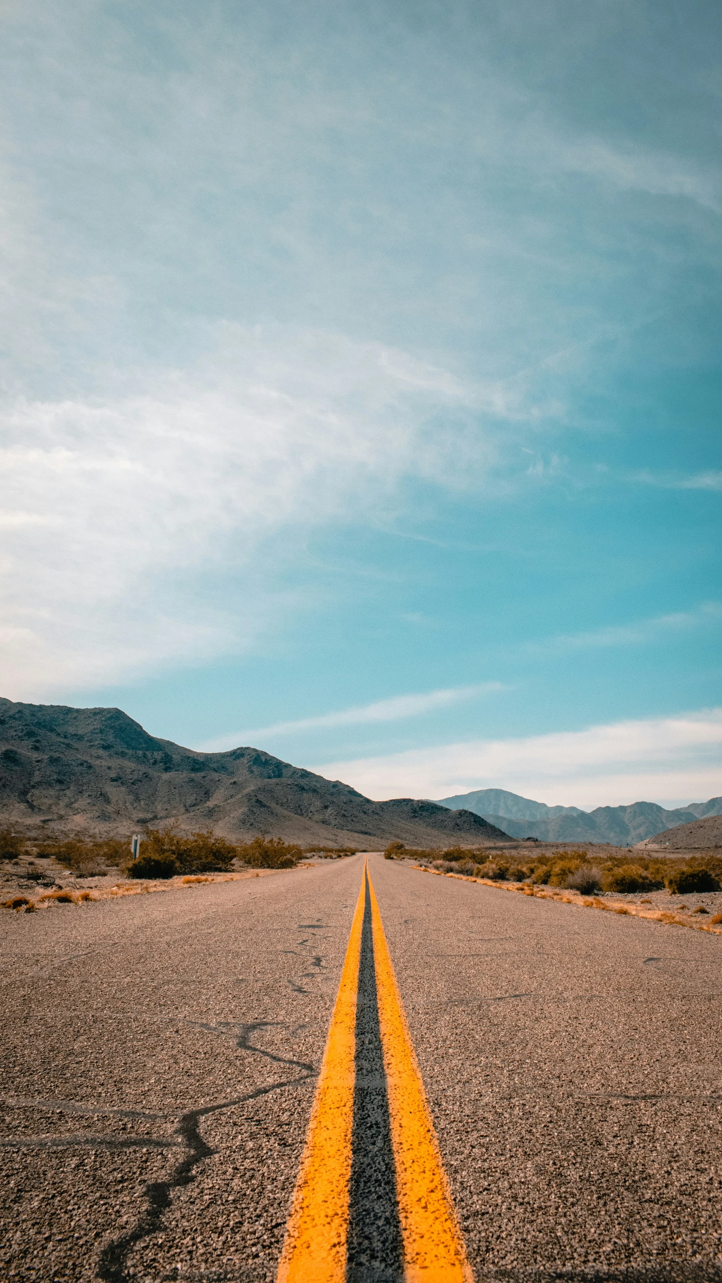 an empty road in the middle of the desert