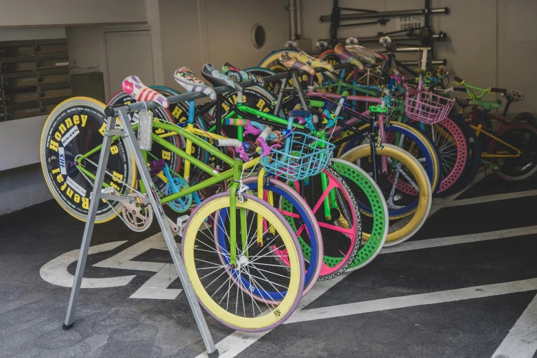 various bicycles lined up next to each other on a parking space