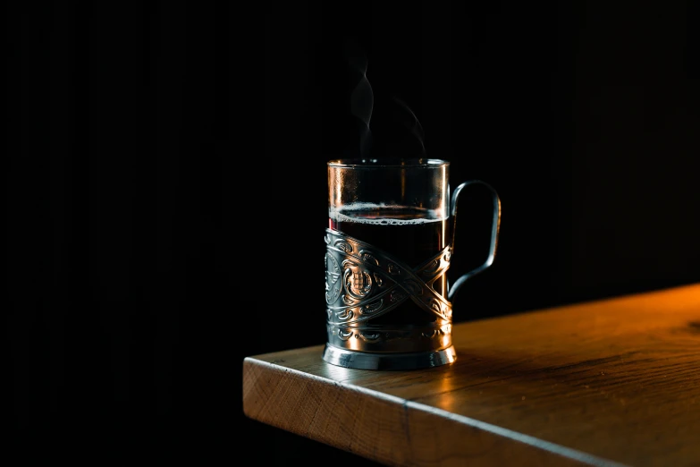 a glass with smoke is on the table