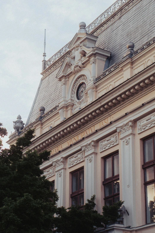 the facade of a building with trees and windows