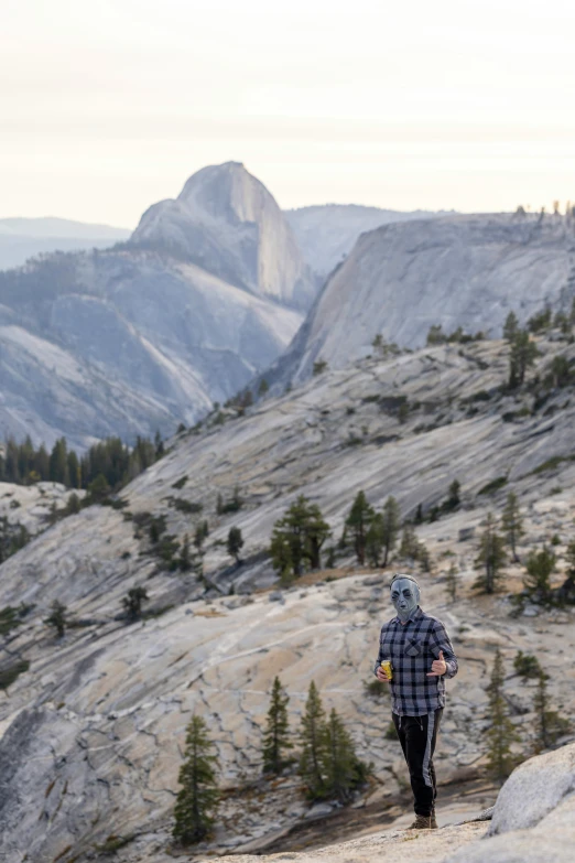 a person that is standing on the side of a mountain