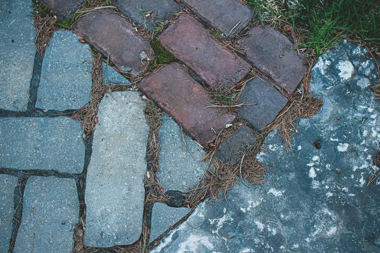 there is a brick walkway that is next to the grass