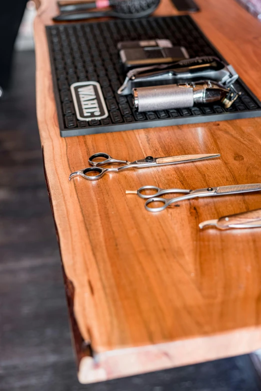 a wooden table topped with keys and other tools